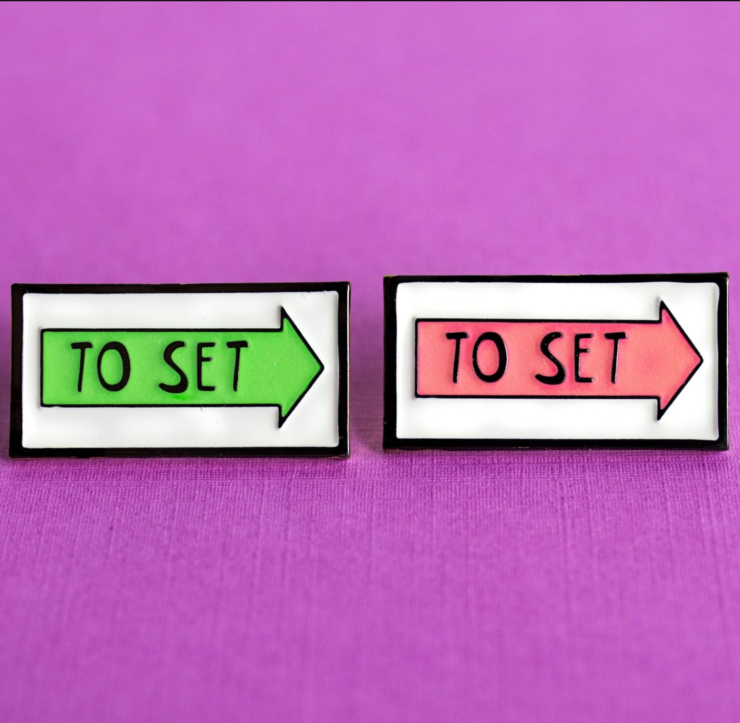 green and pink glow in the dark arrow film locations sign enamel pin
