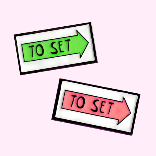 Green and pink glow in the dark vancouver to set film location arrow sign enamel pin
