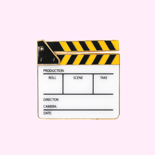 Black and yellow clapperboard enamel pin