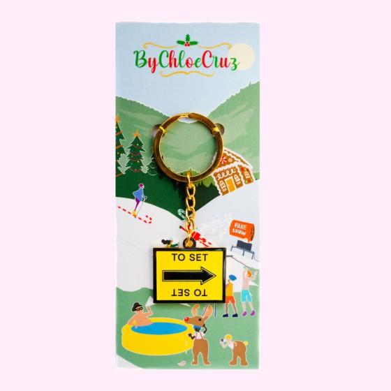 To set black and yellow film arrow location sign keychain with packaging 