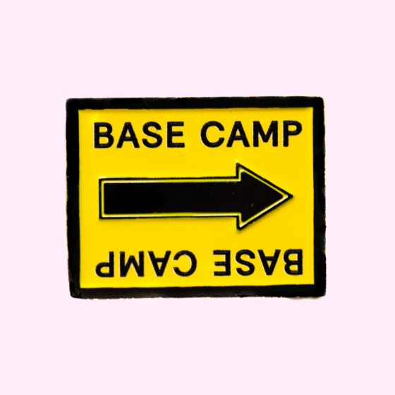 Base Camp Film Location black and yellow arrow sign enamel pin