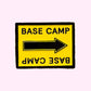 Base Camp Film Location black and yellow arrow sign enamel pin