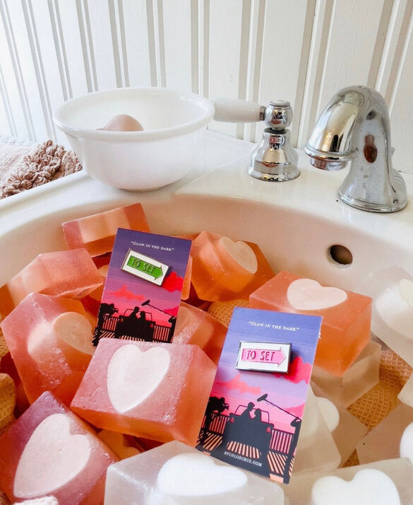 The green and pink film location sign with text to set on a sink with heart soap